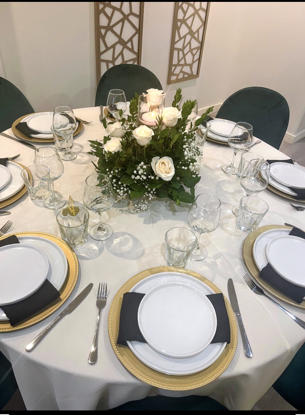 Intimate round table with green velvet chairs